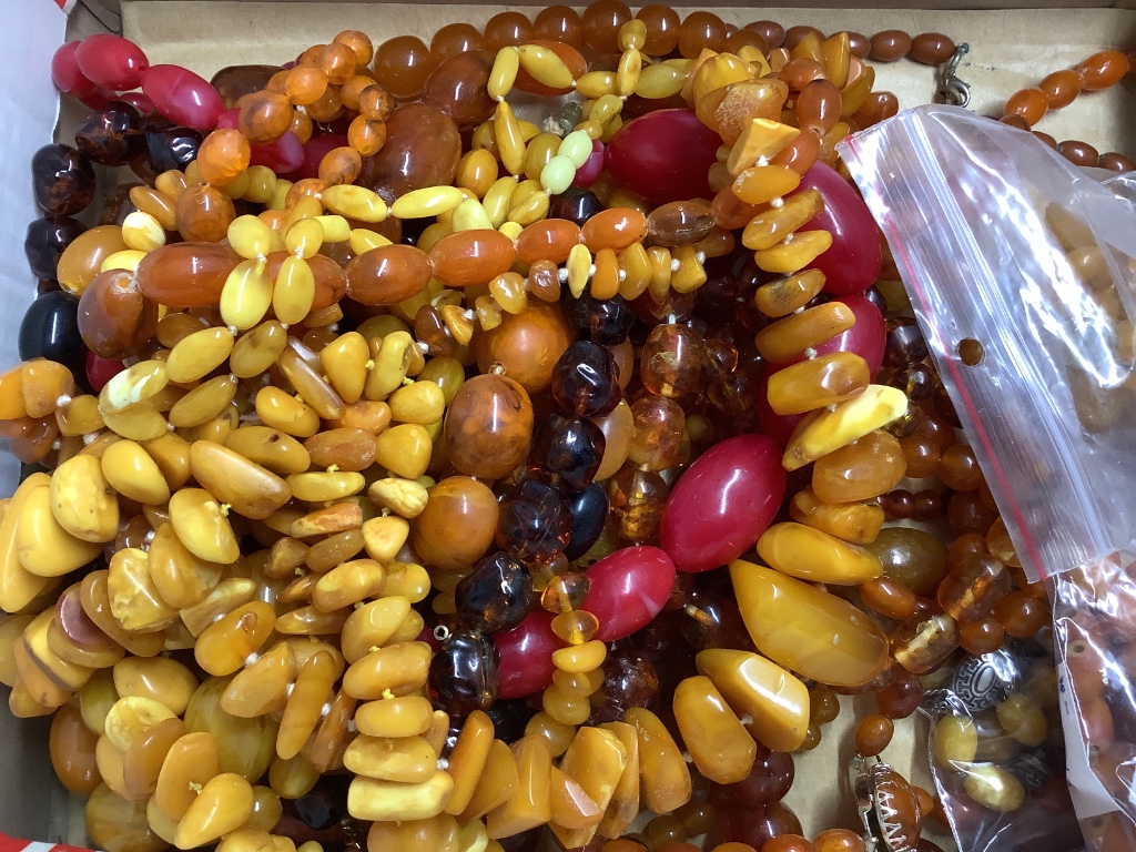 A quantity of assorted amber and faux amber necklaces.